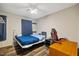 Bedroom with natural light, ceiling fan, desk, and wood laminate flooring at 9801 Honeycutt Rd, Raleigh, NC 27614