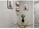 A modern glass-top table with clear chairs is accentuated by curated wall decor at 9801 Honeycutt Rd, Raleigh, NC 27614