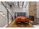 Open concept dining room with stone fireplace, vaulted ceilings, and a grand staircase to the upper level at 9801 Honeycutt Rd, Raleigh, NC 27614