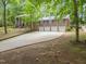 An expansive driveway leads to a stunning brick home with an attached three car garage at 9801 Honeycutt Rd, Raleigh, NC 27614