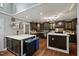 Open kitchen with stainless appliances, a large island, dark wood cabinets and a breakfast nook at 9801 Honeycutt Rd, Raleigh, NC 27614