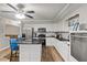 Well-lit kitchen boasts an island with seating, modern appliances and a breakfast bar at 9801 Honeycutt Rd, Raleigh, NC 27614