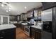 Updated kitchen features stainless steel appliances, dark wood cabinets, and quartz countertops at 9801 Honeycutt Rd, Raleigh, NC 27614