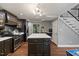 Modern kitchen with stainless steel appliances, dark wood cabinets, kitchen island and staircase at 9801 Honeycutt Rd, Raleigh, NC 27614