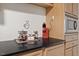 Close-up of the kitchen countertop with a coffee maker and coffee bar at 9801 Honeycutt Rd, Raleigh, NC 27614