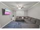 Cozy living room with plush sectional seating and mounted TV for entertainment and relaxation at 9801 Honeycutt Rd, Raleigh, NC 27614