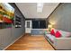 Inviting living room with hardwood flooring, a mounted TV, and custom shelving with decor at 9801 Honeycutt Rd, Raleigh, NC 27614