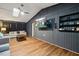 Open living room boasts wood floors, skylights, ceiling fan and mounted TV for entertainment at 9801 Honeycutt Rd, Raleigh, NC 27614
