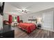 Spacious main bedroom with a ceiling fan, wood-look floors, and ample natural light at 9801 Honeycutt Rd, Raleigh, NC 27614