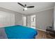 Spacious main bedroom features neutral walls, ceiling fan, wood floors, and ensuite access at 9801 Honeycutt Rd, Raleigh, NC 27614