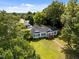 Scenic aerial perspective of the property, highlighting the manicured lawn and mature trees surrounding the home at 1000 College St, Oxford, NC 27565