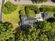 Overhead view of the home's roof, backyard layout, and surrounding mature trees, providing a private setting at 1000 College St, Oxford, NC 27565