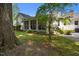 This backyard features a screened-in porch and lush green lawn at 1000 College St, Oxford, NC 27565