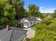 Aerial shot of backyard and garage with a chimney surrounded by lush greenery, creating a private and serene setting at 1000 College St, Oxford, NC 27565