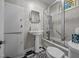 Cozy bathroom featuring a classic pedestal sink, black and white floor, and a glass shower at 1000 College St, Oxford, NC 27565