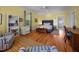 Bedroom featuring light yellow walls, white trim and blue accents at 1000 College St, Oxford, NC 27565