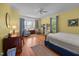 Bright, airy bedroom featuring a bay window, patterned curtains, and a writing desk at 1000 College St, Oxford, NC 27565