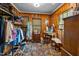 Spacious walk-in closet with built-in shelving, a vanity, and natural wood paneling at 1000 College St, Oxford, NC 27565