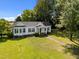 Inviting aerial view of the charming home, highlighting its well-maintained lawn, landscaping, and classic design at 1000 College St, Oxford, NC 27565