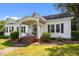 Quaint front porch with brick steps, columns, and decorative details, creating a warm and inviting entrance at 1000 College St, Oxford, NC 27565