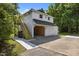 Charming detached garage with wood staircase leading to a second level, complete with a two-car garage and additional side door at 1000 College St, Oxford, NC 27565