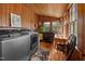 This laundry room has wood paneled walls and features a front loading washer and dryer at 1000 College St, Oxford, NC 27565