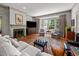 Comfortable living room with hardwood floors and bay window offers a relaxing and inviting space at 1000 College St, Oxford, NC 27565