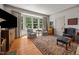 Cozy living room features a bay window, hardwood floors, and a decorative rug for a comfortable setting at 1000 College St, Oxford, NC 27565