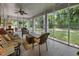 Relaxing screened porch with comfortable seating offers a tranquil view of the landscaped yard at 1000 College St, Oxford, NC 27565