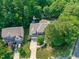 Aerial view of the property, showing the house, surrounding greenery, pool and shed at 101 Quarryrock Rd, Holly Springs, NC 27540