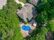 Stunning aerial view of a home with a kidney-shaped pool surrounded by lush greenery at 101 Quarryrock Rd, Holly Springs, NC 27540
