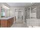 Bathroom boasts a vanity with ample cabinet space, a shower, and mirrored closet doors, enhancing the room's appeal at 101 Quarryrock Rd, Holly Springs, NC 27540
