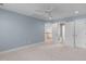 Spacious bedroom with carpet flooring, a ceiling fan, and access to an en-suite bathroom and closet at 101 Quarryrock Rd, Holly Springs, NC 27540