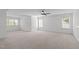 Spacious bonus room with plush carpeting, white trim, and natural light from several windows at 101 Quarryrock Rd, Holly Springs, NC 27540