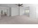 Large bonus room with neutral carpet, white walls, trim and featuring a ceiling fan and several windows at 101 Quarryrock Rd, Holly Springs, NC 27540