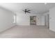 Bright bonus room with neutral carpeting, an adjacent bath, and large windows offering natural light at 101 Quarryrock Rd, Holly Springs, NC 27540