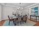 Elegant dining room with a modern chandelier, large mirror, and seating for six at 101 Quarryrock Rd, Holly Springs, NC 27540