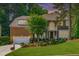 Stately brick home with lush landscaping, attached garage, and mature trees at 101 Quarryrock Rd, Holly Springs, NC 27540