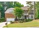 Charming brick home with a manicured lawn, attached garage, and classic architectural details at 101 Quarryrock Rd, Holly Springs, NC 27540