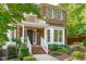 Beautiful brick home with a balcony, mature landscaping, and inviting front entrance at 101 Quarryrock Rd, Holly Springs, NC 27540