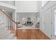 Spacious foyer with hardwood floors, a staircase, and an open view of the living room at 101 Quarryrock Rd, Holly Springs, NC 27540