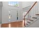 Grand foyer with hardwood floors, high ceilings, staircase, and a view to the living areas at 101 Quarryrock Rd, Holly Springs, NC 27540