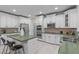 Spacious kitchen with stainless steel appliances, double ovens, and custom white cabinetry at 101 Quarryrock Rd, Holly Springs, NC 27540