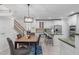 Open concept kitchen with center island, stainless appliances, and adjacent dining area at 101 Quarryrock Rd, Holly Springs, NC 27540