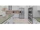 Modern kitchen featuring stainless steel appliances, and custom white cabinetry at 101 Quarryrock Rd, Holly Springs, NC 27540