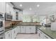 Bright kitchen featuring green countertops, stainless steel appliances, and ample cabinetry at 101 Quarryrock Rd, Holly Springs, NC 27540