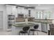 Well-lit kitchen with stainless steel appliances, custom white cabinetry, and center island at 101 Quarryrock Rd, Holly Springs, NC 27540