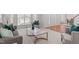 Bright living room featuring large windows, plush seating, and elegant marble-topped coffee table at 101 Quarryrock Rd, Holly Springs, NC 27540