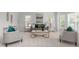 Cozy living room with neutral tones, decorative pillows, and plenty of natural light at 101 Quarryrock Rd, Holly Springs, NC 27540