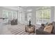 Sunroom featuring neutral paint, tile floors and many windows at 101 Quarryrock Rd, Holly Springs, NC 27540